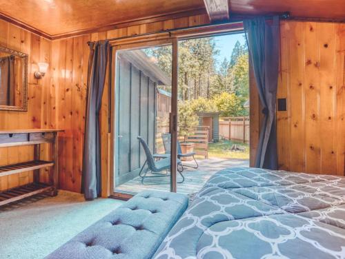 a bedroom with a bed and a large window at Bridlewood Cabin - Meredith Lodging in Welches