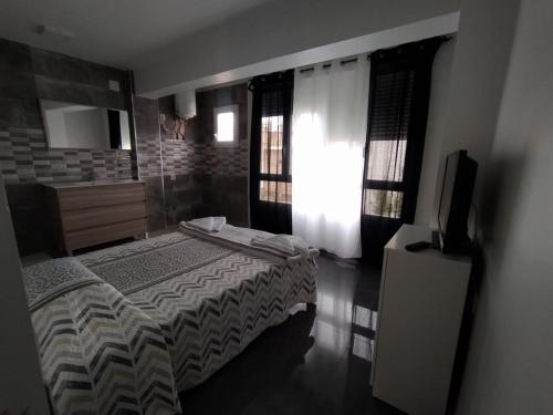 a bedroom with a bed and a flat screen tv at Piley apartamento en vila-real in Villareal