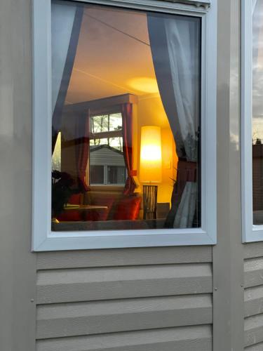 a window with a view of a living room at Deluxe 3 bedroom caravan in Haven's Seton Sands Holiday Village,Wifi in Port Seton