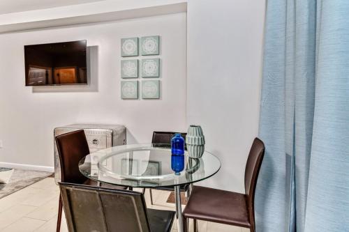 a glass table and chairs in a room at New and Cozy 1BD Apt in the heart of Philly! in Philadelphia