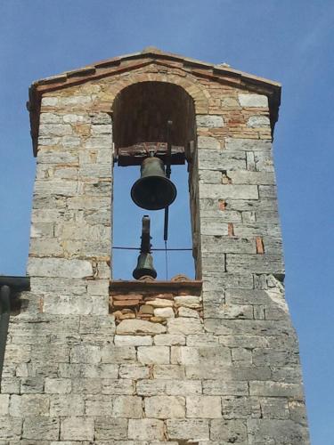a bell on top of a brick tower at BBBagni in Bagni San Filippo