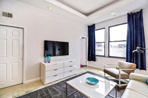 a living room with a couch and a tv at Escape to a 2BD Apartment in the heart of the City in Philadelphia