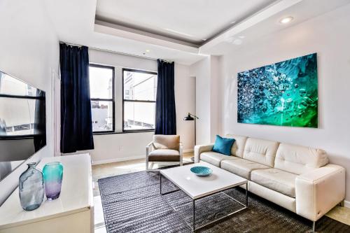 a living room with a couch and a table at Escape to a 2BD Apartment in the heart of the City in Philadelphia