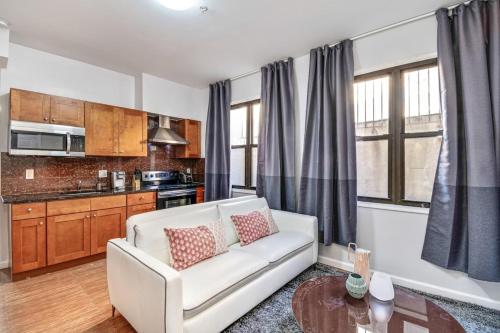 a living room with a white couch in a kitchen at Cozy and stylish 2BD Apt with great location! in Philadelphia