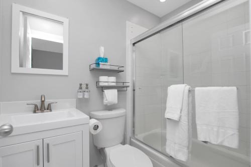 a bathroom with a shower and a toilet and a sink at Majestic Marina Villa- 2 bedroom Village at Hawks Cay in Duck Key