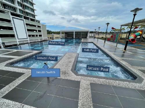 a swimming pool with different parts of it at Baojuwu@2 Bedrooms Akademik Suites Austin Height in Johor Bahru