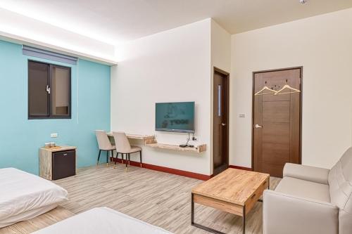 Una cama o camas en una habitación de 僑居民宿