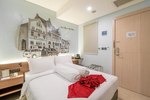 Gulta vai gultas numurā naktsmītnē Azana Style Hotel Bandara Jakarta