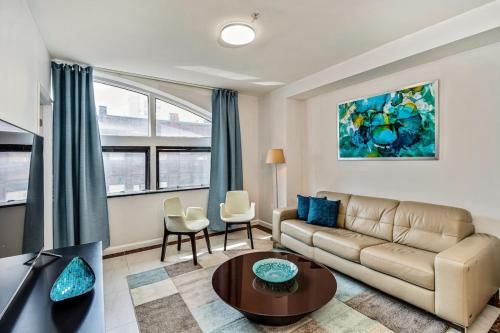 a living room with a couch and a table at 2BD Apartment next to Reading terminal and convention center in Philadelphia