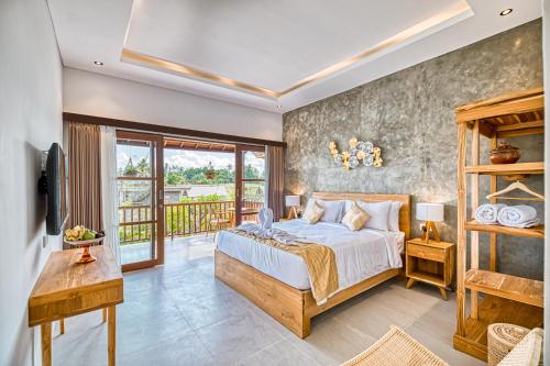 a bedroom with a bed and a balcony at Villa Mirah Ubud in Ubud