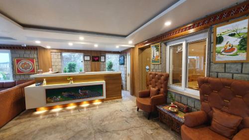 a living room with a couch and a fireplace at Nomadic Inn in Dharamshala