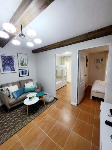 a living room with a couch and a table at Kate's Corner @ One oasis Condo in Cagayan de Oro