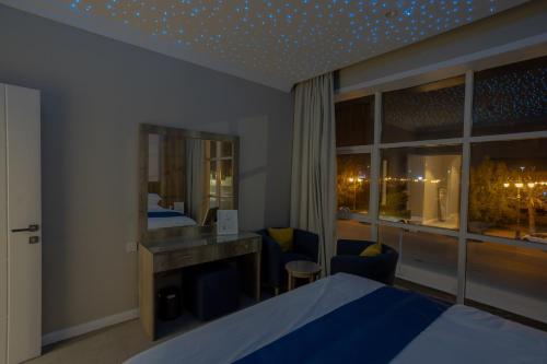a hotel room with a bed and a mirror at Sweet Light Serviced Apartments in Tabuk