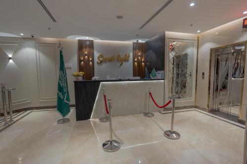 a clothing store with a flag in a room at Sweet Light Serviced Apartments in Tabuk