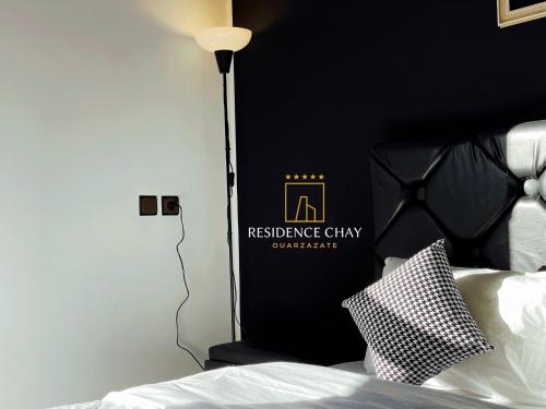 a bedroom with a bed with a black headboard at Residence Chay - Luxury Appart in Ouarzazate