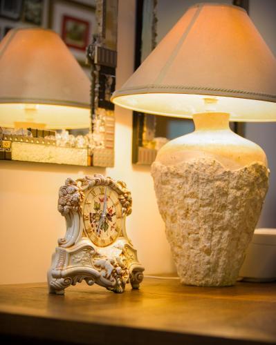 a lamp and a clock sitting on a table next to a lamp at Luxury Penthouse 5 BDR 3 Bath Twin Rain Showers 365 sq mtrs in Port Douglas