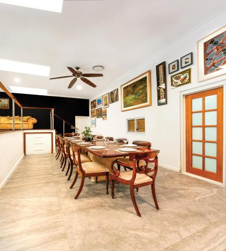 a dining room with a long table and chairs at Luxury Penthouse 5 BDR 3 Bath Twin Rain Showers 365 sq mtrs in Port Douglas