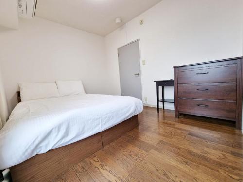 Cama o camas de una habitación en PRISM COURT 綾瀬