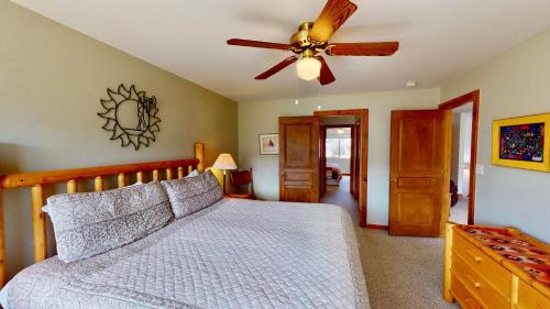 a bedroom with a bed and a ceiling fan at On The Green #3378 in Moab