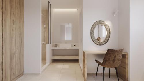 a bathroom with a sink and a mirror and a chair at OSSIANO POOL VILLAS, Heating Pool, 2 min drive to Haraki Beach & 10 to Lindos in Haraki