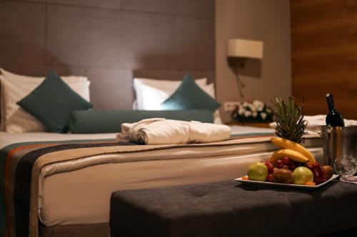 a hotel room with a bed with a tray of fruit at Hotel Yayoba in Tekirdag