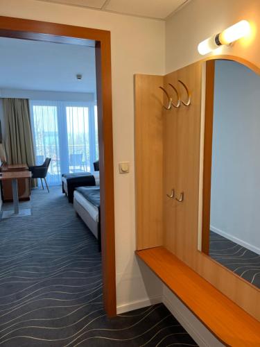 a room with a mirror and a living room at Holiday Resorts in Balatonszárszó