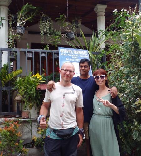 a group of three people standing in front of a house at Innovick Residence in Kandy