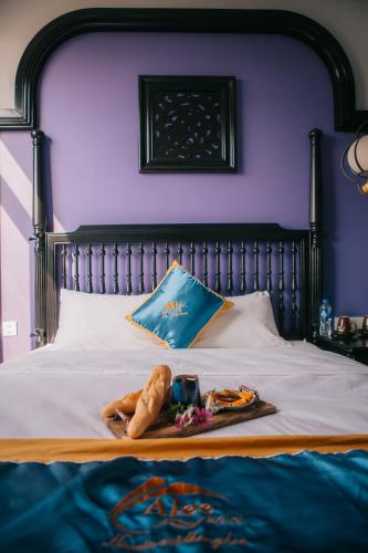 a tray of food sitting on top of a bed at Alee Haiphong Hotel in Hai Phong