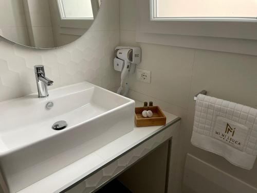 a bathroom with a sink and a mirror at Mimi Leuca B&b in Leuca
