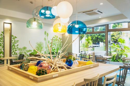 a dining room with a table with colorful glass bulbs at Rembrandt Style Naha in Naha