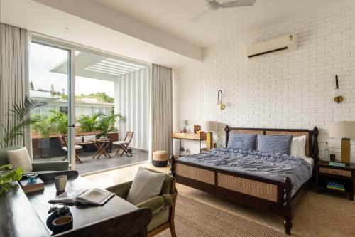 a bedroom with a bed and a living room at LaSierra Estate in Mapusa