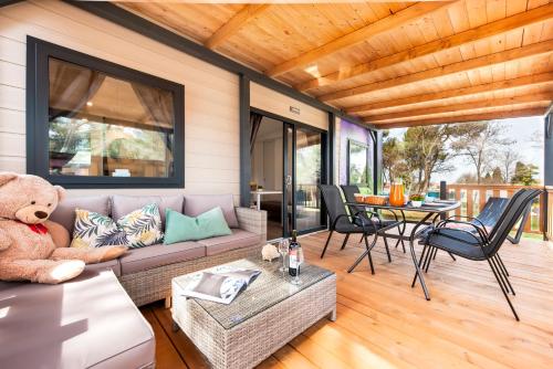 a living room with a couch and a teddy bear at Glamping and Mobile Homes Lavanda - Holiday Centre Bi VIllage in Fažana