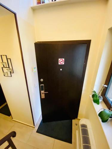 a black door with a no smoking sign on it at Sofia Family House - Free Parking in Sofia