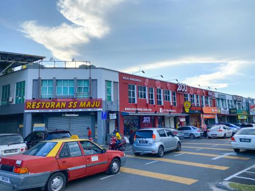 a parking lot with cars parked in front of buildings at BayView Suites Port Dickson By MAISON in Port Dickson