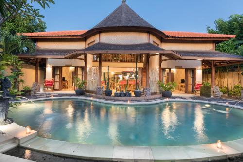 a swimming pool in front of a house at Villa SoDe Balangan by Nagisa Bali in Jimbaran