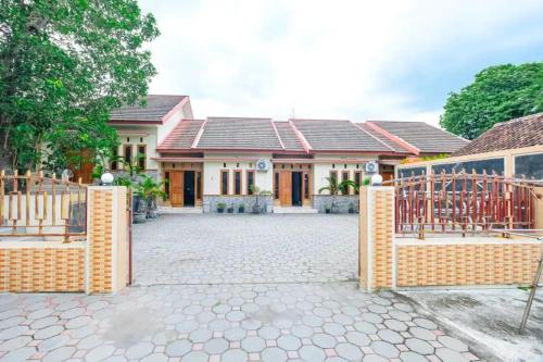 a house with a gate in front of it at Riverside Homestay Jogja in Yogyakarta