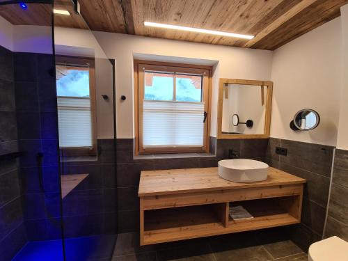 a bathroom with a sink and a shower at Hotel Dorfer in Grossarl