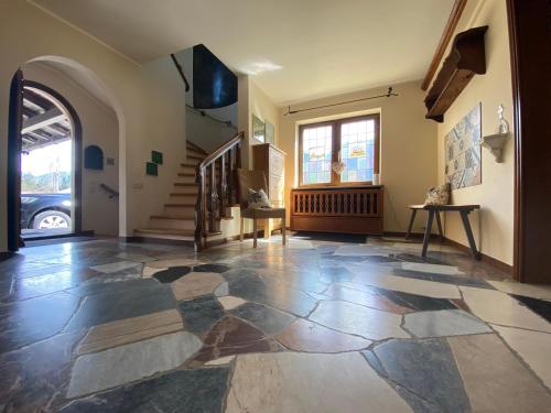 an empty room with a stone floor and stairs at Haus Blindauer Eck in Reit im Winkl