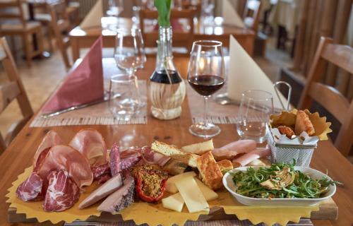 a plate of food on a table with wine glasses at Viole Country Hotel in Assisi
