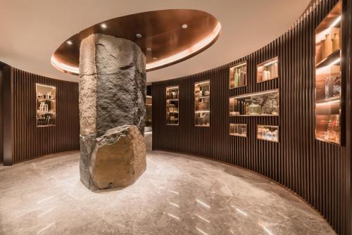 a museum with a large rock in the middle of a room at Ashley Tanah Abang in Jakarta