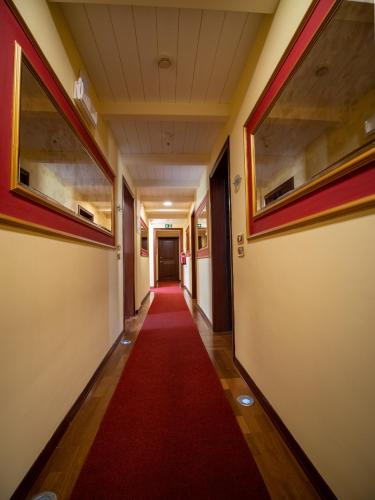 a corridor in an office building with a red carpet at EGO' Residence Ferrara in Ferrara