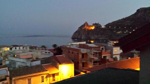 a view of a city at night with a mountain at B&B Capo Sant'Alessio in SantʼAlessio Siculo