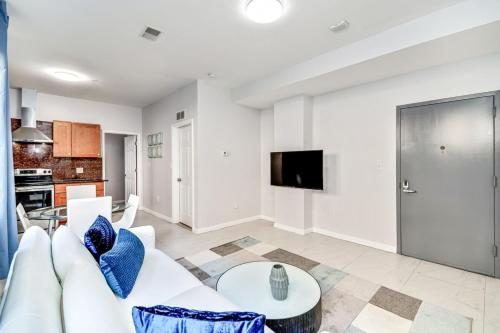 a living room with a white couch and a table at The blue wall 2BD apartment with excellent location in Philadelphia