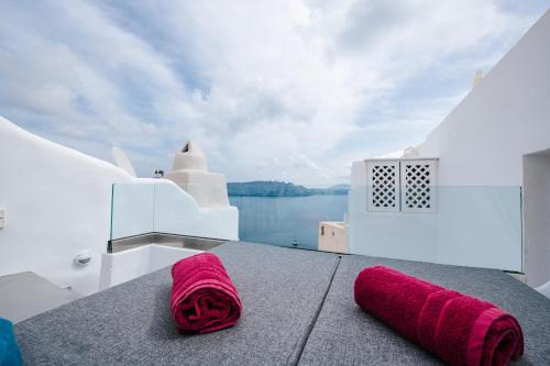 a pair of pink slippers sitting on the deck of a boat at Virginia's Cave Villas in Oia