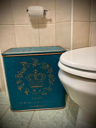 a blue box sitting next to a toilet in a bathroom at Ravenna d'Amare in Marina di Ravenna