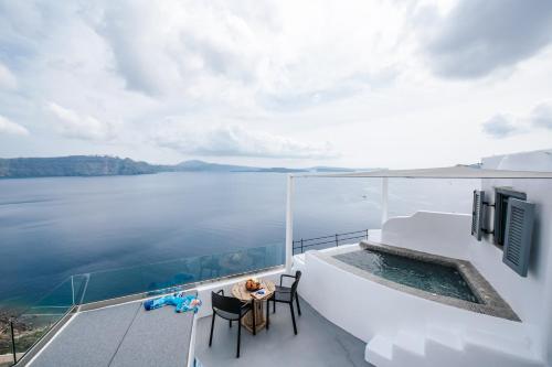 a view of the water from the balcony of a house at Virginia's Cave Villas in Oia