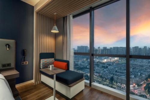 a hotel room with a view of a city at Holiday Inn Express Meishan Dongpo, an IHG Hotel in Meishan