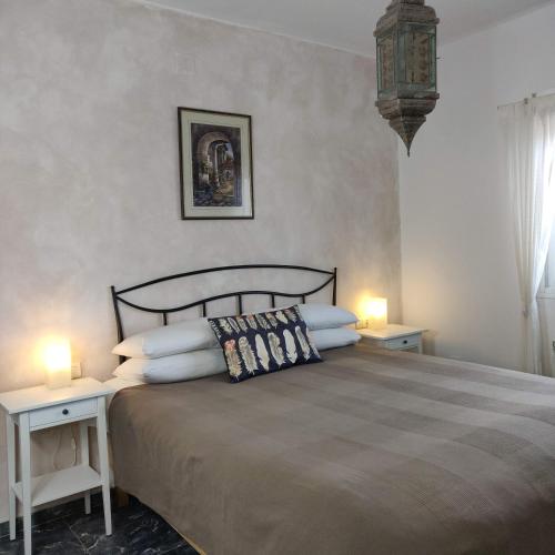 a bedroom with a large bed with two tables and two lamps at New Leaf Cortijo Apartment ,Moclin in Moclín