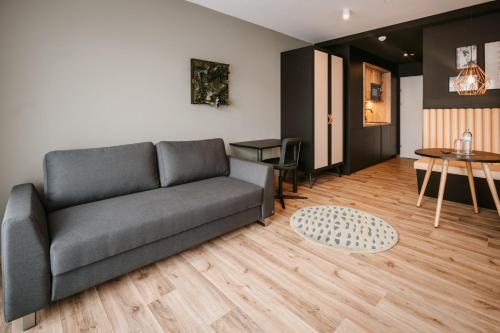 a living room with a couch and a table at Rioca Vienna Posto 2 in Vienna