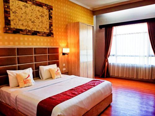 Postel nebo postele na pokoji v ubytování UNP Hotel & Convention